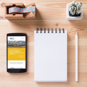 Topview of office stuff on wooden working table. Mock up. Sticky tape, note paper , white blank notebook, post-it note, pencil and blank white screen smartphone.