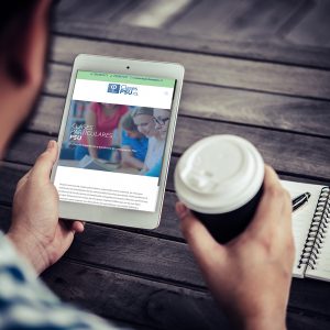 Young man using digital tablet while drinking Coffee sitting at home garden, Relaxing in the morning.