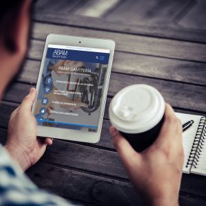 Young man using digital tablet while drinking Coffee sitting at home garden, Relaxing in the morning.